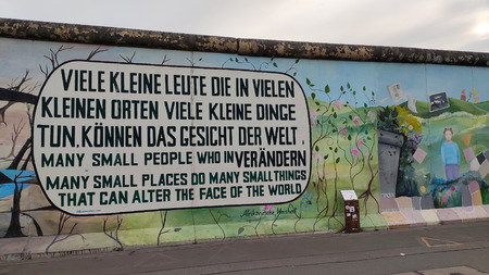 Berlin, Germany- September 7, 2019 a Street Full of Life on a Sunny Day With Tourists and Berliners Passing by the Berlin Wall at the East Side Gallery. It's a 1.3 Km Long Part of Original Berlin Wall Which Collapsed in 1989 and Now is the Largest World Aのeditorial素材