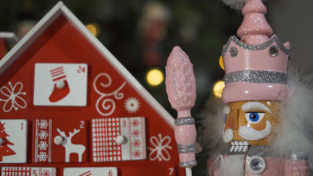 Wooden Tree Advent Calendar in Front of a Real Christmas Tree Decorated Nutcracker Soldier Toys. Fairy Lights on a Christmas Tree With Blurred Backgroundの写真素材