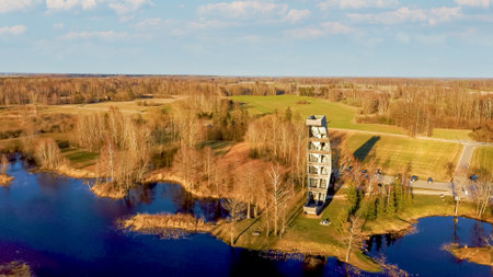 Modern Construction Observation Tower in Kirkilai. Green Nature With Pond in Sunset at Birzai Eldership, Panevezys County, Lithuania. 4K UHD Amazing Aerial Dron Shotの写真素材