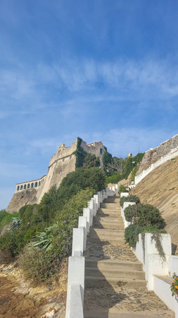 View of Medieval Fort Forte De Sao Clemente Over the Mira River With Small Boat in Sunny Day With Clear Blue Sky. Vila Nova De Milfontes, Portugal, Rota Vicentina Coast. The Fisherman Trailの写真素材