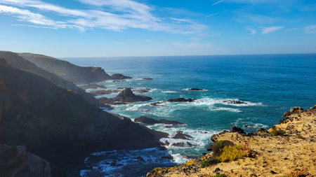 The Almograve Beach With Black Basalt Rocks in Alentejo Coast, Portugal. In the Footsteps of Rota Vicentina. Hiking Fisherman Trail.の写真素材