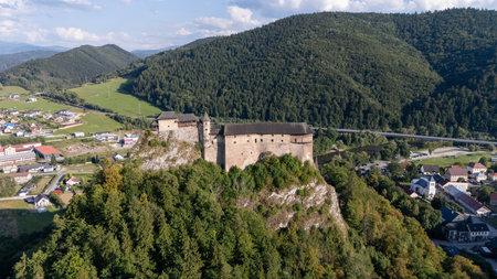 Orava Castle perched on dramatic cliffs above the Orava River in Slovakia. Sunset light reveals medieval architecture and breathtaking landscape. Ideal for history and travel visualsの写真素材