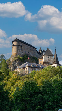 Orava Castle perched on dramatic cliffs above the Orava River in Slovakia. Sunset light reveals medieval architecture and breathtaking landscape. Ideal for history and travel visualsの写真素材