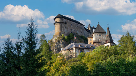 Orava Castle perched on dramatic cliffs above the Orava River in Slovakia. Sunset light reveals medieval architecture and breathtaking landscape. Ideal for history and travel visualsの写真素材