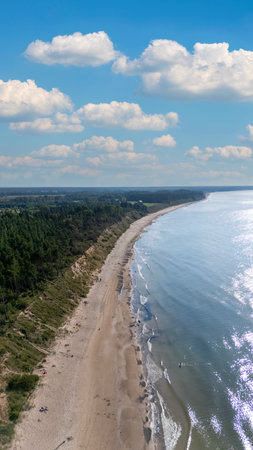 Drone Flight Over Jurkalne Steep Coastline On A Sunny Summer Day Revealing Baltic Sea Shore Sandy Trails Green Fields And Peaceful Nature Landscape In Latviaの写真素材
