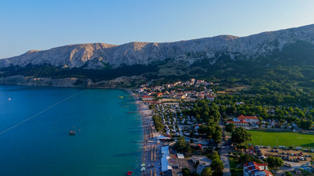 Baska Beach and Coastline With Clear Turquoise Water, Marina Boats, City Street, Sunny Summer Sunset Aerial View on Krk Island, Croatia Adriatic Sea, Vela Plaza Beach, Mountains and Campsite Cityscapeの写真素材