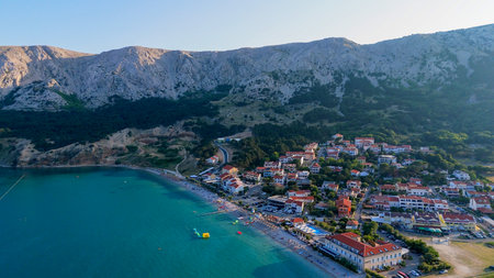 Baska Beach and Coastline With Clear Turquoise Water, Marina Boats, City Street, Sunny Summer Sunset Aerial View on Krk Island, Croatia Adriatic Sea, Vela Plaza Beach, Mountains and Campsite Cityscapeの写真素材