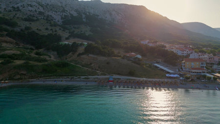 Baska Beach and Coastline With Clear Turquoise Water, Marina Boats, City Street, Sunny Summer Sunset Aerial View on Krk Island, Croatia Adriatic Sea, Vela Plaza Beach, Mountains and Campsite Cityscapeの写真素材