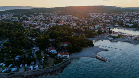 Aerial View of Krk, the Capital City of the Croatian Island of Krk, Adriatic Coast, With Harbor and Red Tiled Roofs. Blue Sea,with Sailboats, Sandy Beaches and the Historic Old Town at Sunset Croatiaの写真素材