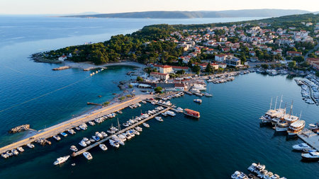 Aerial View of Krk, the Capital City of the Croatian Island of Krk, Adriatic Coast, With Harbor and Red Tiled Roofs. Blue Sea,with Sailboats, Sandy Beaches and the Historic Old Town at Sunset Croatiaの写真素材