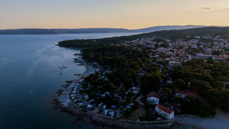 Aerial View of Krk, the Capital City of the Croatian Island of Krk, Adriatic Coast, With Harbor and Red Tiled Roofs. Blue Sea,with Sailboats, Sandy Beaches and the Historic Old Town at Sunset Croatiaの写真素材
