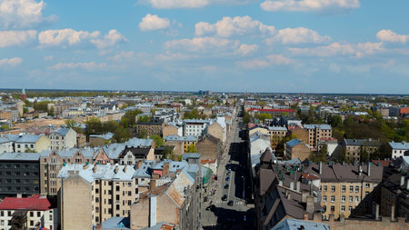 Aerial Drone View Of Riga Panorama In Latvia On A Sunny Spring Day Showcasing The Rooftops Of Houses...