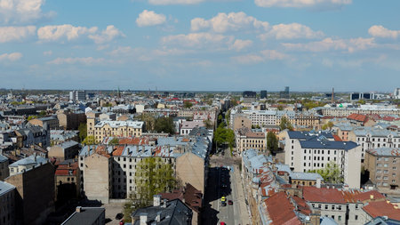 Aerial Drone View Of Riga Panorama In Latvia On A Sunny Spring Day Showcasing The Rooftops Of Houses...