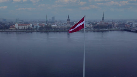Drone View Of Riga Old Town With Latvian Flag Waving In Foreground Aerial Panorama Of Historic City Center, Daugava River And Urban Skyline On A Outumn Day In Latviaの写真素材