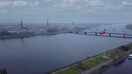 Drone View Of Riga Old Town With Latvian Flag Waving In Foreground Aerial Panorama Of Historic City Center, Daugava River And Urban Skyline On A Outumn Day In Latviaの写真素材