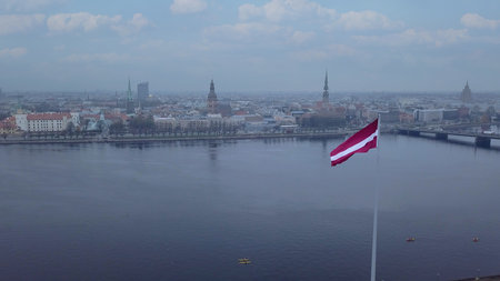 Drone View Of Riga Old Town With Latvian Flag Waving In Foreground Aerial Panorama Of Historic City Center, Daugava River And Urban Skyline On A Outumn Day In Latviaの写真素材