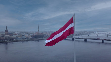 Drone View Of Riga Old Town With Latvian Flag Waving In Foreground Aerial Panorama Of Historic City Center, Daugava River And Urban Skyline On A Outumn Day In Latviaの写真素材