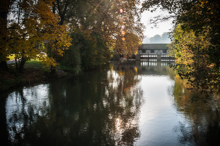 Autumn - Old bridge in autumn misty parkの写真素材