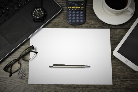 An image of writing desk, with a sheet of paperの写真素材
