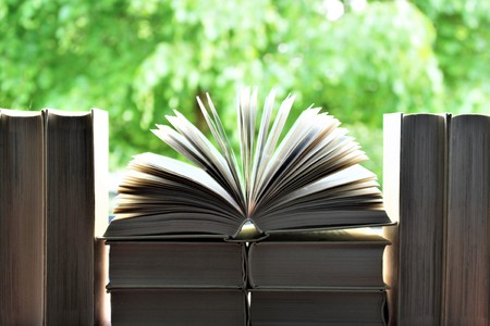 An image of a book in front of a open windowの写真素材