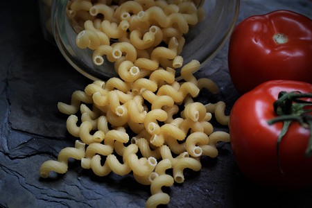 An image of dark pasta with tomatoesの写真素材