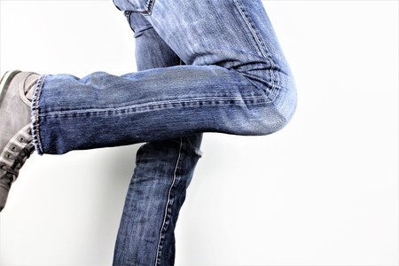 Bottom halfway to man standing with bow legs, people indoors studio shotの写真素材