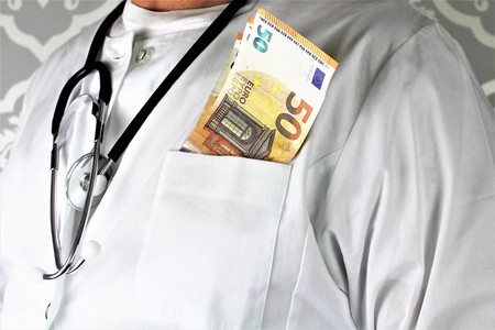 An image of a corrupt doctor with moneyの写真素材