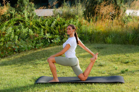 Healthy sports woman training on the grass.の写真素材