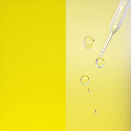 Pipette with drops of liquid on yellow background.の写真素材