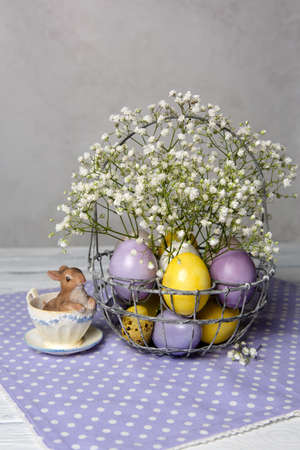 Easter purple and yellow eggs on violet polka dot napkin.の写真素材