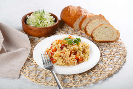 Rice with vegetables and colesaw with cucumbers and whole grain bread.の写真素材