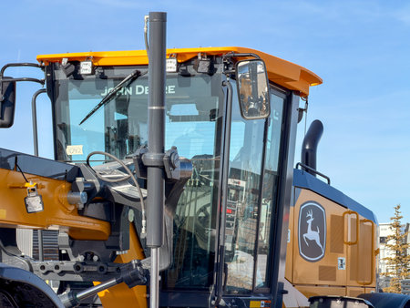 Regina, Canada - February 2026: Close-up of John Deere heavy construction machine cabin with glass...