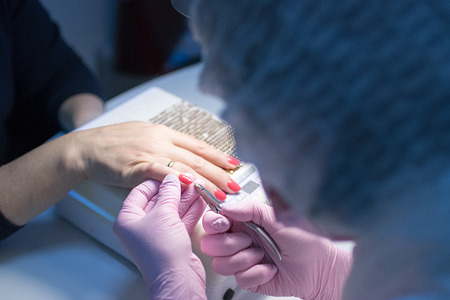 master in the beauty salon getting a manicure clientの写真素材