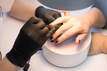 master in the beauty salon getting a manicure clientの写真素材