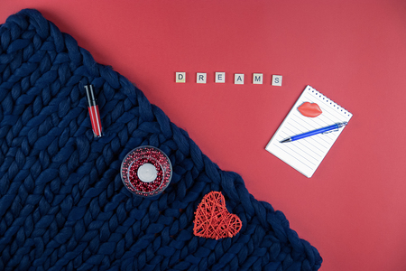 on red and blue background women's accessories, cosmetics and decorative items, Notepad and penの写真素材