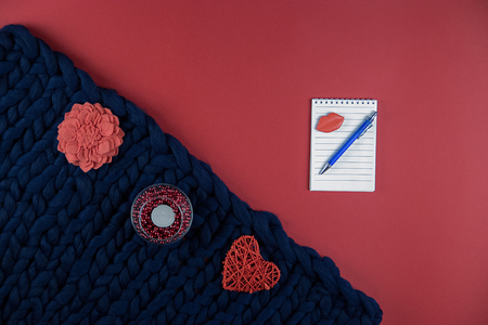 on red and blue background women's accessories, cosmetics and decorative items, Notepad and penの写真素材
