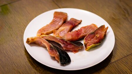 Cooking Delicious Meals At Home.
Large Sliced Pieces Of Raw Carp On A White Plate Standing On A Wooden Table.の写真素材