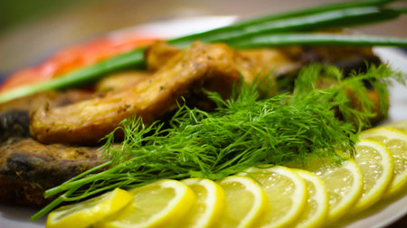 Cooking Delicious Meals At Home.A Few Slices Of Fried Fish And Sliced Lemon Slits On A White Plate....