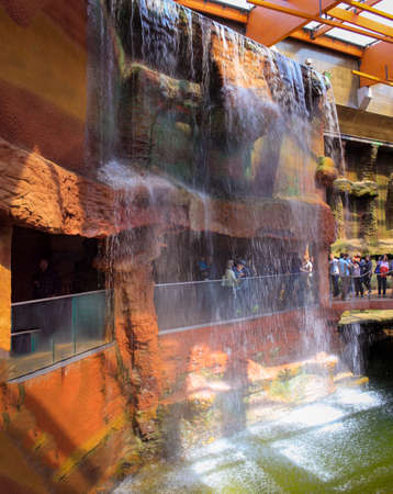 Wroclaw, Poland - May 03, 2015: Wroclaw City Zoo. People Pass Under An Artificial Waterfall.のeditorial素材