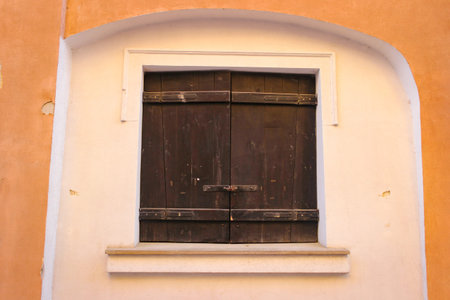 Closed Old Wooden Shutters On The Window In An Ancient Medieval Building.の写真素材