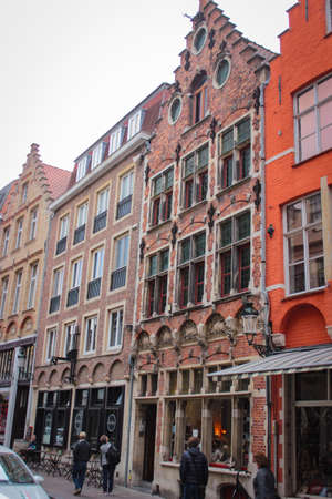 Bruges, Belgium - May 12, 2018: Roofs And Windows Of Old Authentic Brick Houses On Street Vrijdagmarktのeditorial素材