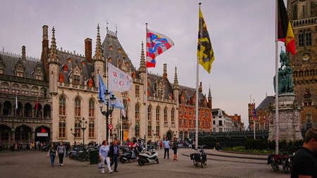 Bruges, Belgium - May 12, 2018: Tourists And Locals Walk On A Sunny Day On Main Square.のeditorial素材