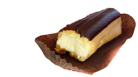 Delicious dessert, isolated image on a white background. The eclair is covered with chocolate that...