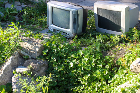 Symbol of the end of an era. Lamp TV and computer monitor are thrown into a wasteland between old...