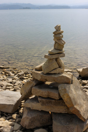 Rock balancing (or stone balancing) figure on lake shoreの写真素材