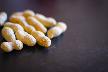 Peanuts in the peel stand on a black background