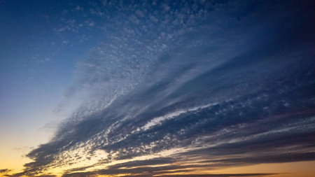 Incredibly beautiful sunrise over an endless horizon. The sky is dark blue at the top and yellow...