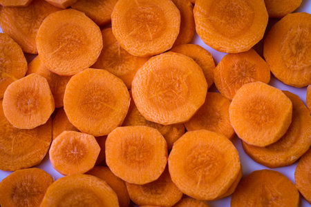 Delicious food background. Raw carrots cut into mugs