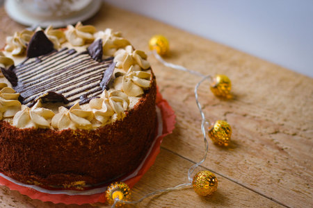 Delicious chocolate cake covered with chocolate chips and topped with a buttercream decoration