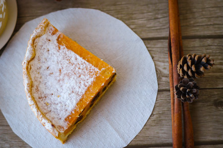 A piece of sweet pie made of cottage cheese and pumpkin, sprinkled on top with powdered sugar